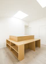 Kids play area light shaft with integrated desks and shelving