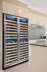 155 Bottle Dual Zone Wine Cooler (SKU: VT-155SBW)
For sleek, stylish and sophisticated wine storage for your prized collection, the VT-155SBW by Vinotemp is the perfect solution. This dual zone wine cooler allows you to set two separate temperatures to provide optimum conditions for up to 155 bottles of both your reds and whites. Convenient digital temperature controls make setting the ideal temperature a simple task. Contemporary styling includes a black body with stainless steel door trim and a dual paned glass door. Fifteen pull-out wood shelves provide easy access to your storage space, where 77 standard 750ml bottles fit in the upper zone and 78 in the lower. A front-exhaust allows this cooler to be placed as a built-in or freestanding unit. Door swing is reversible*, providing you the option of installing two side by side for extra wine storage. 