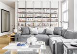 Living Room, Rug Floor, Coffee Tables, Light Hardwood Floor, Sectional, Table Lighting, Shelves, End Tables, and Floor Lighting  Photo 1 of 8 in Home Living Ideas by Greg Ciro Tornincasa from This New York Apartment Is What Dreams Are Made Of