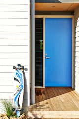 When you have a clear favorite color, it's a no-brainer to paint your front door. And it's hard to beat the cool factor that comes from a vibrant blue front door like this one. The shade is a modern mid-blue that's not too light and not too dark. Best of all, it connects back to the accent colors in other favorite items like the owner's longboard.