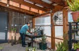 Shed & Studio A small greenhouse is attached to the garage. The vintage barn wood on the back wall was salvaged from an old barn on the ranch that had fallen down decades ago.  Photo 9 of 11 in 10 Greenhouses That Will Inspire You to Grab Your Gardening Tools from The Goat Sheds