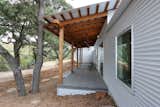This is the covered porch off the guest bedrooms. Simple, exposed wood rafters, beams, and columns. 