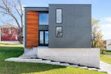 Exterior, House Building Type, Stone Siding Material, Metal Roof Material, Metal Siding Material, Wood Siding Material, and Flat RoofLine Northern facade, main entry  Photo 3 of 8 in Sunset House by Carrie Stallwitz