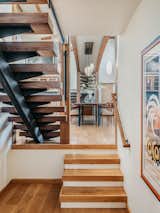 Hallway and Medium Hardwood Floor Floating walnut staircases on either side of the great room lead to the first and second floors.  Photo 6 of 15 in Contemporary Masterpiece by DAVIS GONTHIER