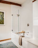 The bathroom in the second wing is fitted with a six foot tub featuring honed white marble.