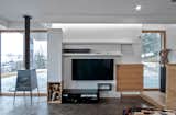 Living room corner window. Concrete floor, special made furniture in natural oak and lacquered mdf fiber. Gervasoni Rocking Chair, Sofas by Cassina