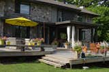 Outdoor, Back Yard, Trees, Grass, Hardscapes, Gardens, and Wood Patio, Porch, Deck Multi level deck with covered section  Photo 12 of 23 in Prairie School Inspired Stone Home on the Golf course by Luc Bedard