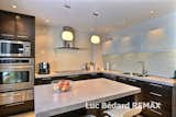 Kitchen, Cooktops, Range, Range Hood, Microwave, Ceramic Tile Floor, and Mosaic Tile Backsplashe Kitchen  Photo 19 of 23 in Prairie School Inspired Stone Home on the Golf course by Luc Bedard