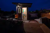 Rooftop deck at night. Featuring art work by Sarah Zeffiro