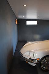 The garage was relocated, creating better access in and out of the garage and allowing the rest of the rear of the house to open to the exterior. The new location buffers the living spaces from the roadway.  The new garage acts as a showplace for the owners beloved restored 1970 Citroen DS.