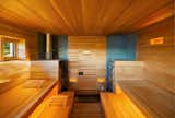 This sauna designed Andre Tchelistcheff Architects stays warm in the well-lit rolling hills of upstate New York.