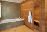 Natural wood warms the stone palette of this master bathroom designed by Mark Reilly Architecture.  Photo 7 of 10 in 10 Sterling Saunas in Modern Homes