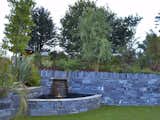 Small pond built into the join of two slate walls, providing welcome visual and aural interest.