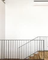 Simplicity with white walls, black steel balustrade and oak timber floors 