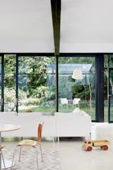 A new wall of 10-foot-high triple-paneled sliding doors and windows allow ample natural light to brighten and warm the residence.