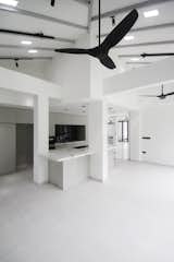 Two rooms were combined and ceiling removed to create this light and airy kitchen and dining space.