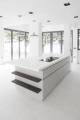 The kitchen island overlooks the dining room and garden beyond.