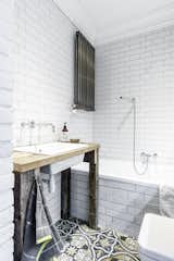 Bath Room, Pedestal Sink, Soaking Tub, Wood Counter, Drop In Sink, Subway Tile Wall, and Ceramic Tile Wall  Photos from Loft in Poland