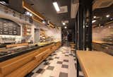 The counter and lighting are finished by meticulously selected wooden planks that may link to traditional oven fuel.