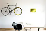 A large workshop wall provides adequate space for working with clients. There is even a place to hang Maciej's beloved bicycle with his company's colorings.