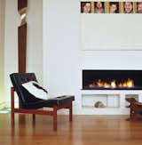 Minimal hole in the wall gas fire, with a black interior of polished stone. This large fire provides a focal point in this beautiful contemporary space.   Photo 6 of 9 in Bespoke Gas Fireplaces by The Platonic Fireplace Company