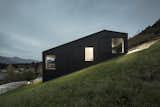 An Austrian vacation home’s design references its mountainside setting and expansive views across the valley, and is an exercise in contrasts: its exterior is painted black, but its interiors are light-filled and clad in natural wood.