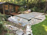 Exterior lawn, fountain, terrace, water channel, deck and window wall