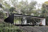 Tepotzlan Bungalow. Tepotzlan, Mexico
Architects: Cadaval &amp; Sola-Morales
This minimalist construction of steel, glass and concrete tucked into the Mexican jungle was painted black and lined with floor to ceiling windows to “minimize its visual impact on the landscape”.