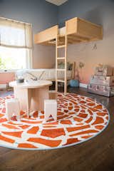 A custom-colored circular Kyle Bunting rug anchors the room and is reminiscent of a giraffe.
