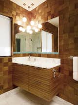 This nature-inspired bathroom  layers wood tones and sculptural texture.