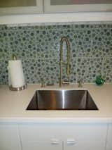 The deep stainless steel sink is by Kraus.  Faucet and soap dispensers by Danze.