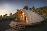 The Autonomous Tent - It's kind of like a yurt, only it feels tight and has style.

The high tech manufacturing process ensures absolute precision providing simple installation and a tight seal between fabric and frame that cannot be accomplished with a yurt, making the structure look and feel more permanent.  If you've stayed in a yurt, you know all about the noise.