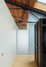 In the back right, you'll see that one of only two rooms touch the shell of the home. Fiedler Marciano Architecture kept the ceiling open and airy, respecting the integrity of the original architecture of the loft.