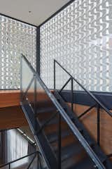 The stair ascends four floors to the private roof deck. The aluminum screen was a multi-purpose and lightweight privacy solution.