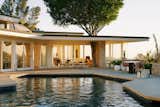 Outdoor, Concrete, Trees, Back Yard, Walkways, Swimming, Stone, Concrete, and Large  Outdoor Stone Swimming Walkways Photos from Elvis Presley’s Former L.A. Midcentury Is Now a Swoon-Worthy Design Showroom