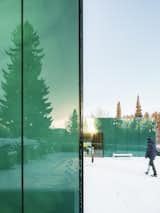 Exterior, Flat RoofLine, Metal Roof Material, Metal Siding Material, and Glass Siding Material One of architect Gert Wingårdhs' favorite parts of the building is the reflective glass.  Photo 2 of 7 in Architect Gert Wingårdh Builds a Dazzling Emerald Office in a Swedish Cemetery
