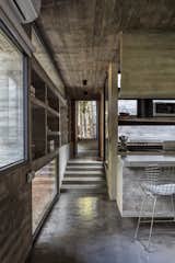 Revealed courtyards throughout the home change the atmosphere due to the effects produced by the light entering.  Photo 5 of 8 in A Staggered Concrete Home in Argentina Nestles in the Woods