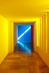 Only one wall in the pool corridor at Casa Gilardi is yellow; the other is white. Light enters via the adjacent courtyard, resulting in a warm glow.