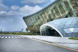 The Heydar Aliyev International Airport, in Azerbaijan's capital of Baku, receives more than six million passengers a year. Concave glass allows light to fill the warm interiors, which is home to live trees.&nbsp;