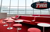 The Sunken Lounge, which&nbsp;reminiscent of 2001: A Space Odyssey,&nbsp;is the heart of the TWA Hotel. The plush, red carpet is the same you'll find in the long, minimalist tunnel entry, where indirect light illuminates the curved wall, which results in no shadows.