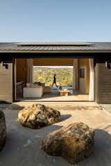 Existing boulders from the site were moved and used as minimalist landscaping. Solar panels fixed to the roof were prefabricated off-site so as not to disturb the surroundings.