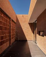 The architects introduced ventilation in one of the courtyards by stacking bricks vertically with spacing, creating the effect of a breeze-block wall.