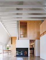 Simple and durable, yet elegant materials such as polished concrete, second-grade oak flooring, and maple plywood are used throughout. Interior and exterior connect visually through a wall of glass doors to the garden and fields beyond.