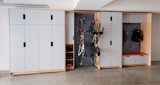 This project gave us an opportunity to develop a line of garage cabinetry that provides a perfect staging area for any family’s special interests. This system includes tall cabinets to provide ample storage to keep large bins out of sight and open shelving for more frequently used items. 