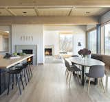 Dining Room, Bench, Bar, Ceiling Lighting, Recessed Lighting, Chair, Table, Light Hardwood Floor, Wood Burning Fireplace, and Stools  Photo 7 of 18 in Ridge House by rowland + broughton