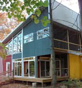 exterior of cabin...built of wood and glass, no drywall inside, all plywood walls and floors, with a steampunk stair railing.  Photo 1 of 3 in eco friendly flooring for a summer cabin by Communique design