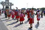 Native women dressed in traditional attire lining up for the possession into the 'New Basilica'.