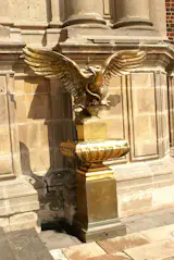 This statue is the symbol of the founding of Mexico City. 
The legend says that the chief was told in a dream to journey with his people. He will build the new city when he fins 'an eagle, perched on a cactus, devouring a snake'.