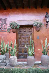 Here an original carved door from the courtyard. The scroll work on the door is in the spanish colonial style. The door is permanently closed off.