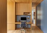 the study has multiple functions  as is needed in a New York City apartment, as a laundry, tucked within the cabinetry, a guest bedroom with a built-in murphy bed and yoga area.